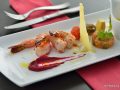 FOOD SHOT - Grilled King prawns served with vegetables of the day , beetroot and orange puree , saffron lemon butter sauce